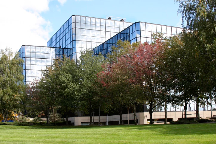 building exterior with lawn and trees