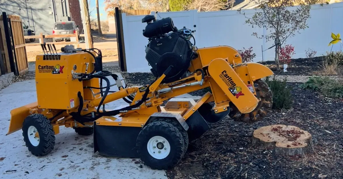 Professional stump grinder removing a tree stump below ground level